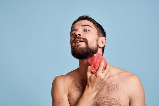 man with bare shoulders shower clean skin care morning hygiene blue background. High quality photo