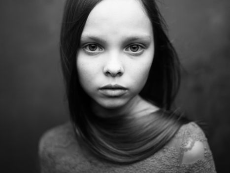 Gray photo of a girl in a cropped view of a dress. High quality photo