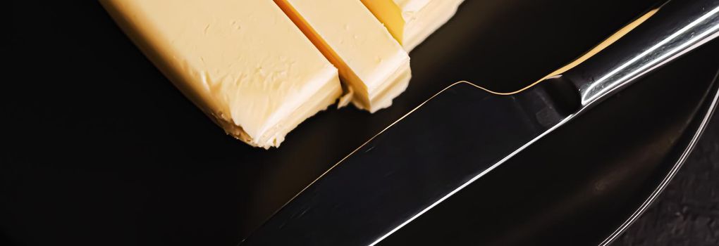 Sliced organic butter block and knife, breakfast food closeup