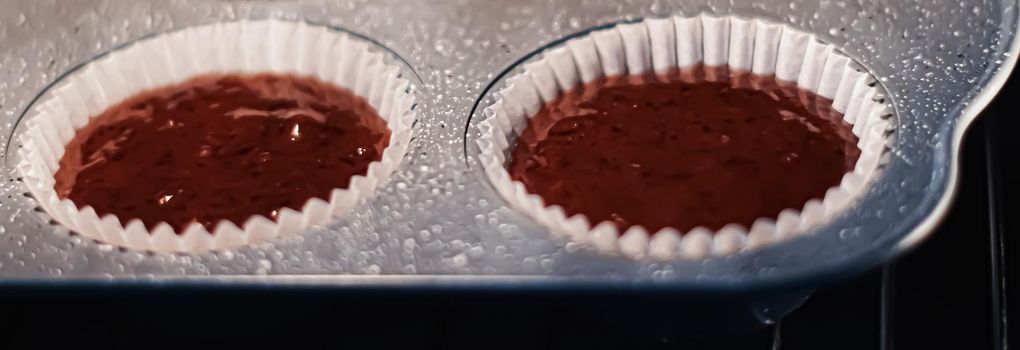 Chocolate muffins baking in the oven, homemade comfort food recipe concept