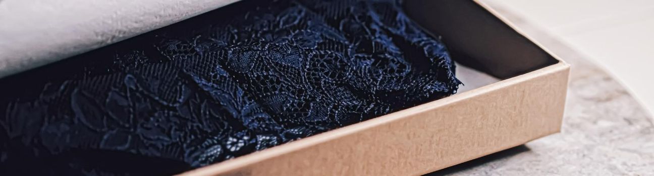 Lace garment inside elegant gift box as luxury purchase, closeup