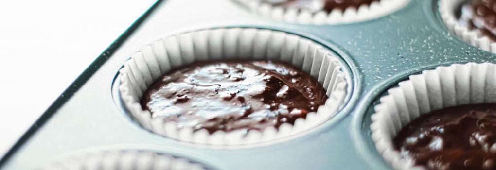 Chocolate muffin or cupcake batter in a pan ready to bake, homemade comfort food recipe concept