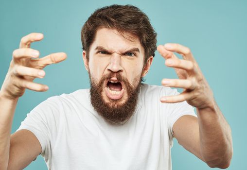 Portrait of an emotional man in a white T-shirt and a thick beard. High quality photo