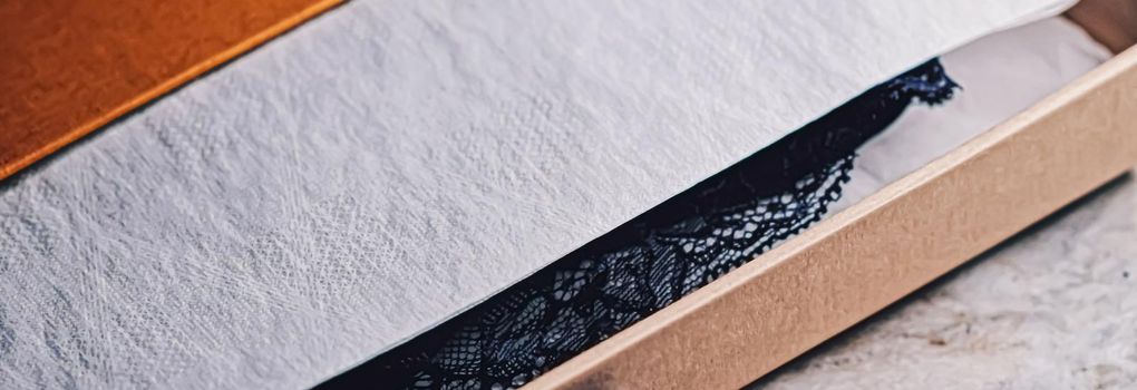 Lace garment inside elegant gift box as luxury purchase, closeup