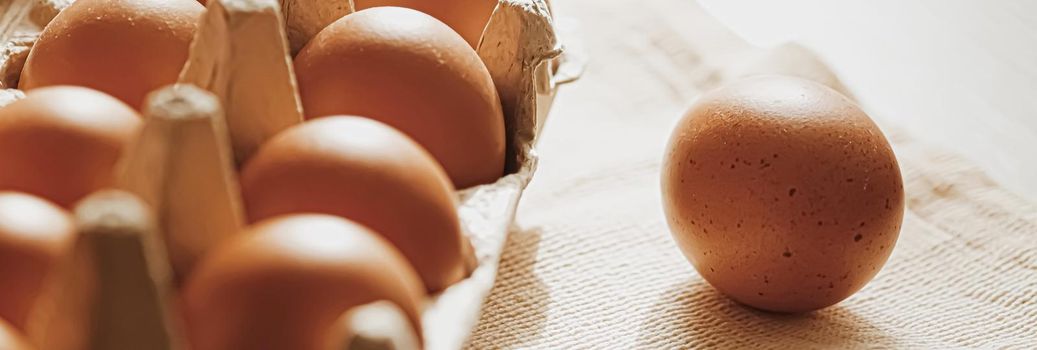 organic farm eggs in egg box and rustic cloth napkins, closeup