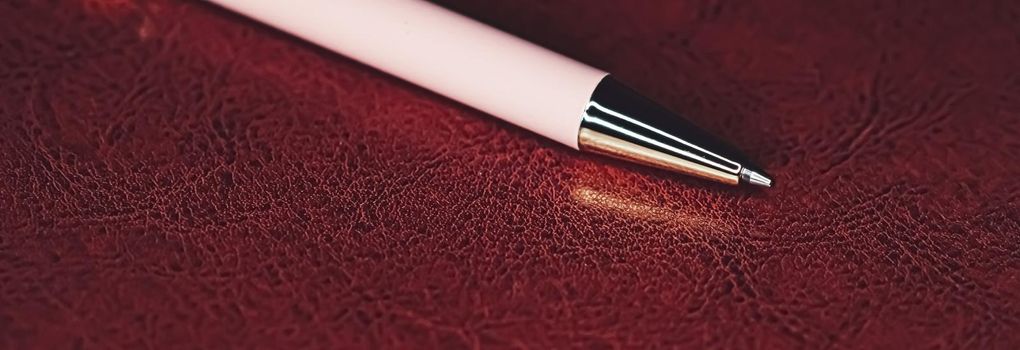 Pen and leather briefcase in office, closeup