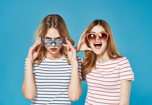 cheerful women in striped t-shirts wearing sunglasses fashion communication studio. High quality photo