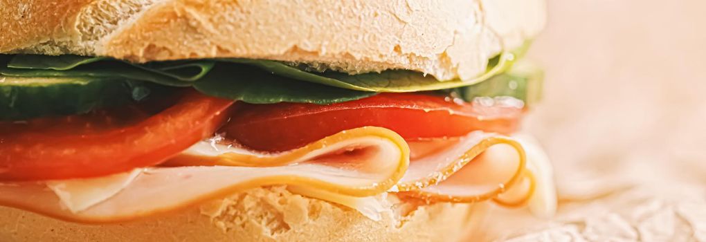 Sandwich with ham, cheese and fresh greens, take out comfort food closeup