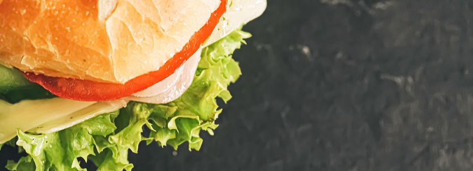 Sandwich with ham, cheese, veggies and lettuce, fast food closeup