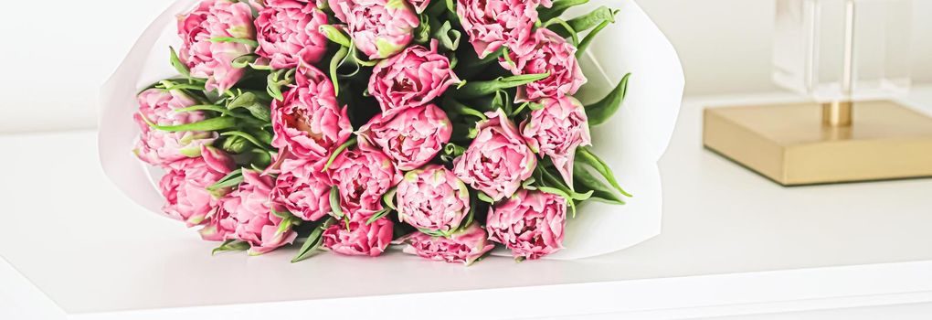 Bouquet of fresh cut pink tulips in an elegant interior, home decor closeup