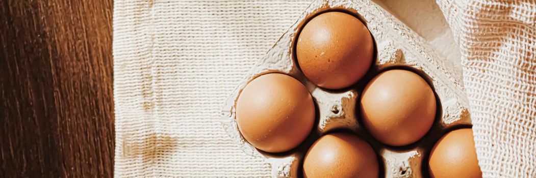 organic farm eggs in egg box and rustic cloth napkins, closeup