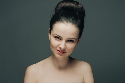 brunette with bare shoulders surprised look emotions clear skin. High quality photo
