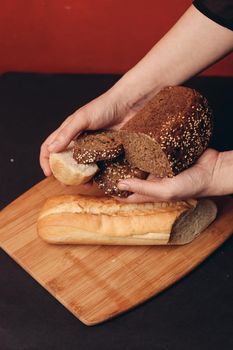 sliced white baguette and a loaf of rye bread on a board. High quality photo