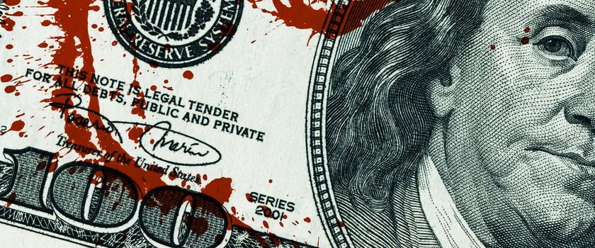 Blood money concept. Fragment of a one hundred dollar bill with blood stains