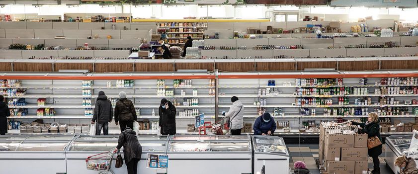 Kyiv, Ukraine - Mar. 23, 2020: Buyers in a large grocery shopping center in Kiev buy essential goods during the coronavirus pandemic