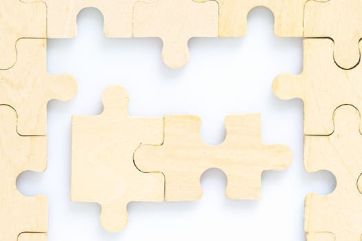 Shot of wooden jigsaw puzzle pieces on white background,Business concept