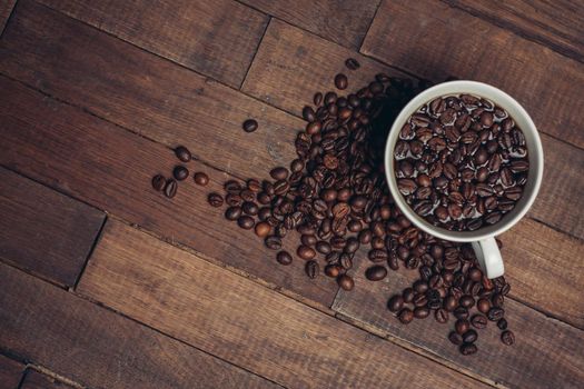 cup with coffee grains on a wooden table aromatic drink. High quality photo