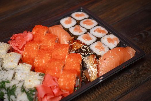 sushi rolls on a wooden table seafood fish filling Wasabi ginger. High quality photo