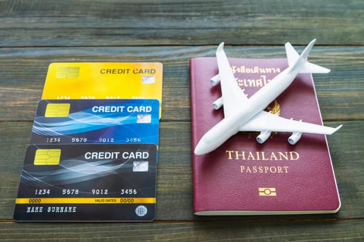 Passport with  credit card on brown wooden desk background, Preparation for Traveling concept