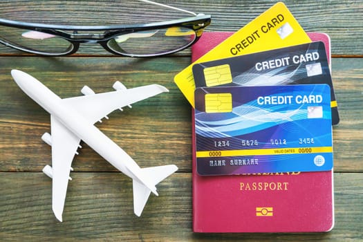 Passport with  credit card on brown wooden desk background, Preparation for Traveling concept