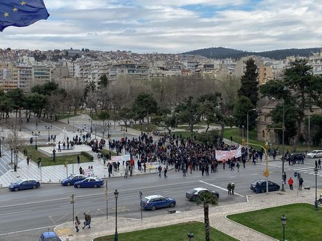 Day view of crowd marching at Aristotelous main square.