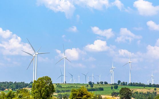 Wind turbine  generators line the hilltops and Aerial landscape with blue sky