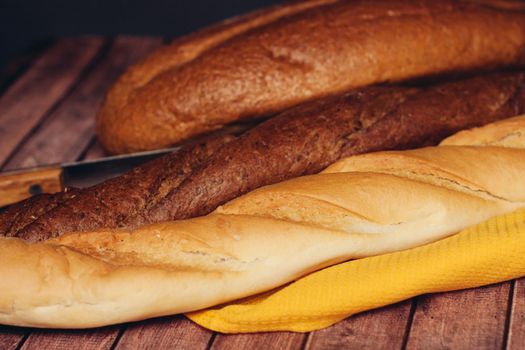 sliced loaf yellow napkin wooden table baked goods. High quality photo
