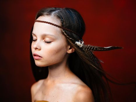 beautiful girl with headdress feather choker closed eyes side view. High quality photo