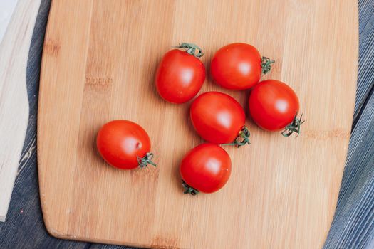 italian pasta by hand cherry tomatoes wooden table. High quality photo