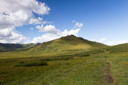 Green mountain valley and sky, travel..On the Oroy pass. Mountain Altai. Siberia. Russia.