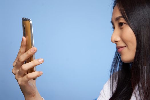 pretty asian woman looking at phone technology communication lifestyle. High quality photo