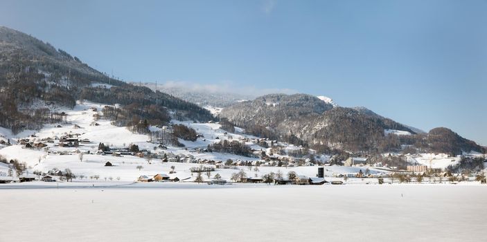 Winter view of Davos, famous Swiss skiing resort. Swiss Alps near Davos. Snow-covered mountains