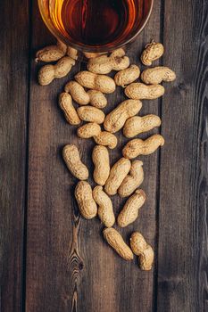 beer mug with peanuts in shells on wooden background pub alcoholic. High quality photo