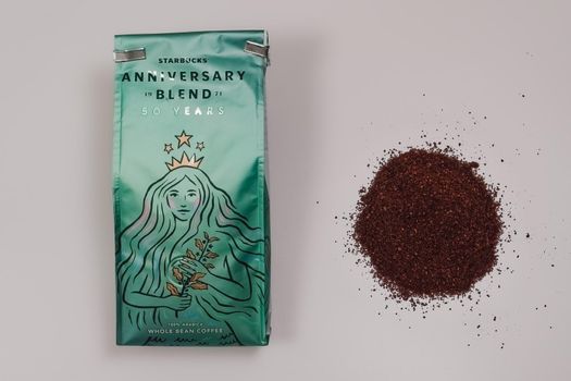 Beverage package with siren company logo next to portion of fresh ground coffee.
