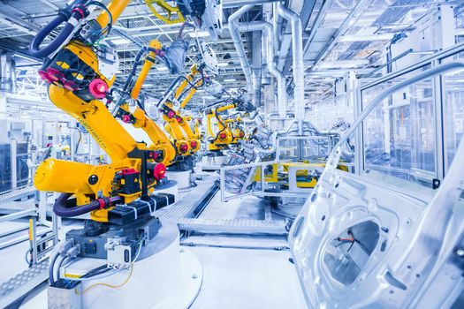 robotic arms in a car plant