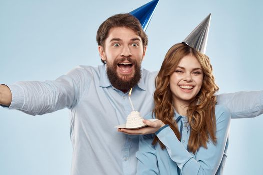 Party man and woman birthday cake corporate fun blue background. High quality photo