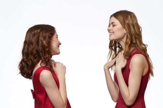 Mom and daughter stand side by side and fun family joy light background. High quality photo