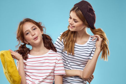 funny mom and daughter fashion studio lifestyle fun blue background family. High quality photo