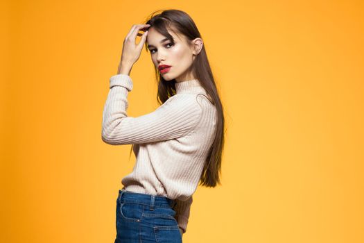 Cute brunette red lips fashionable clothes studio yellow background. High quality photo