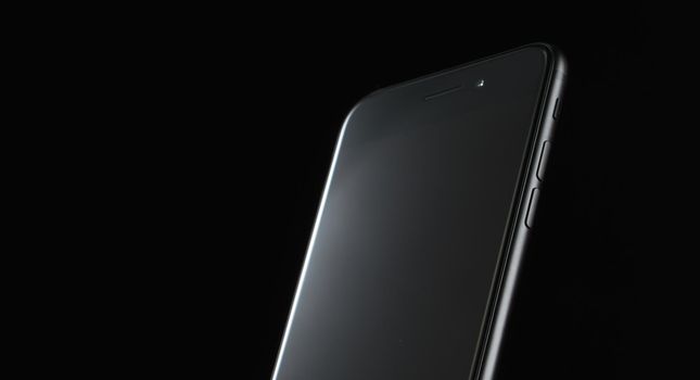 touchscreen mobile phone on black background new technologies without buttons. High quality photo