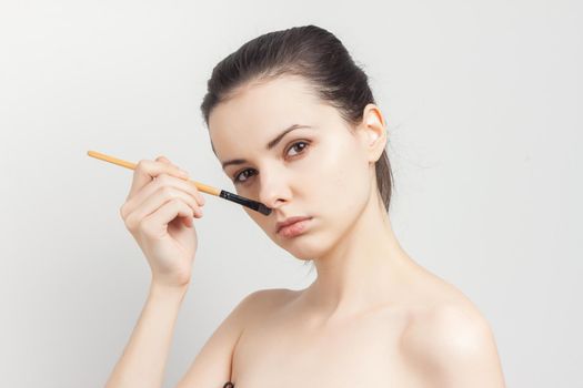 woman applying brush cream on face skin care rejuvenation. High quality photo