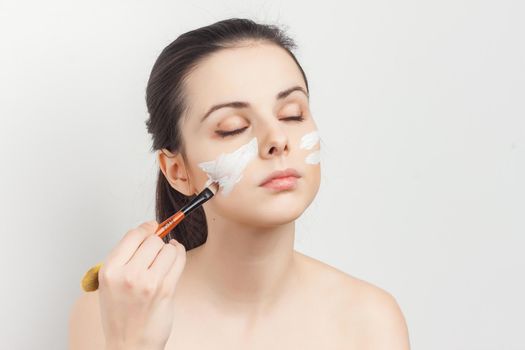 pretty woman naked shoulders face cream skin care cosmetology. High quality photo