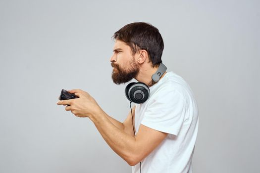 Man with headphones Joystick in hands playing technology lifestyle. High quality photo