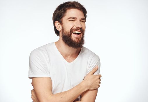 Emotional man on a light background gesturing with his hands cropped view. High quality photo
