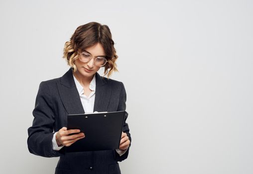 Business woman with folder of documents classic suit glasses finance. High quality photo
