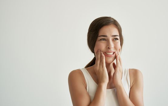 brunette in white t-shirt wipes her face with a handkerchief health problems cold. High quality photo