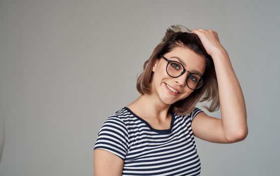 woman in striped t-shirt emotion smile glasses model. High quality photo