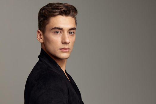 handsome man black jacket fashion hairstyle close-up attractive look model. High quality photo