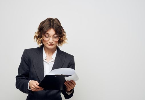 Woman with documents business finance light background classic suit. High quality photo