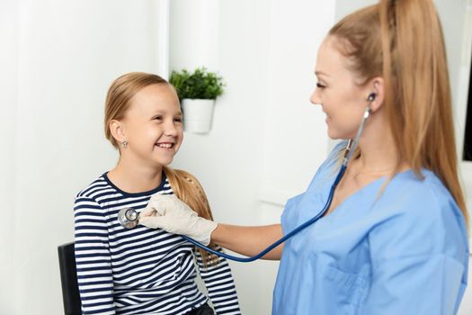 woman doctor examines a child in hospital treatment. High quality photo